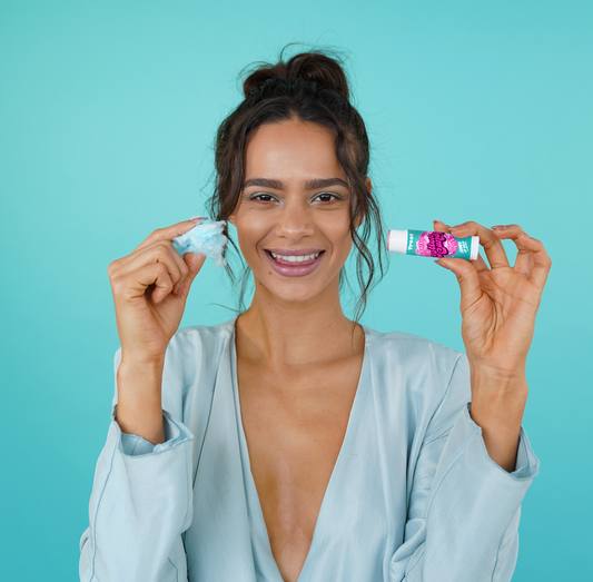 woman holding shimmering cotton candy jumbo lip balm from treat beauty 