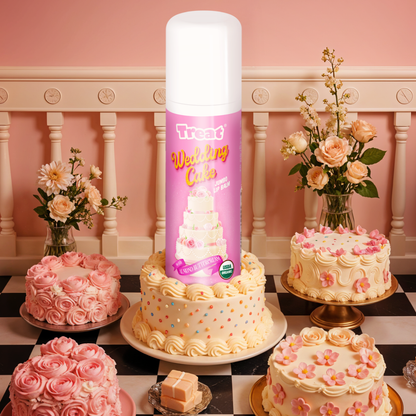 Decorative cake with a Treet product in the center, surrounded by other cakes and flowers on a checkered floor.