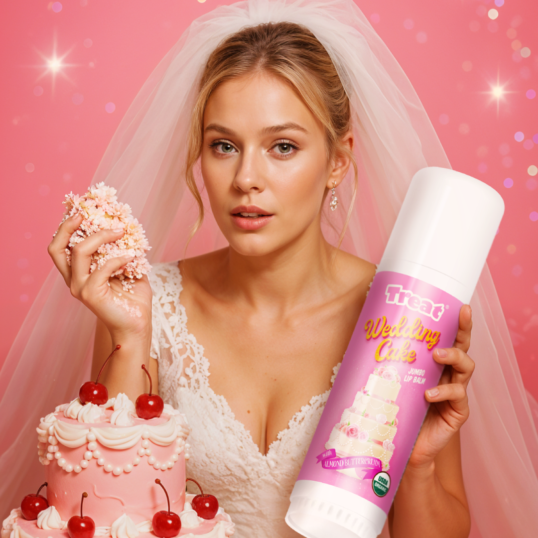 Woman in wedding dress holding a pink cake and a can of whipped cream against a pink background